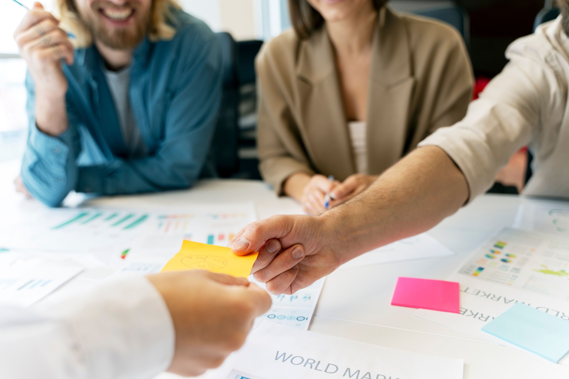 Business team exchanging ideas during brainstorming session with sticky notes